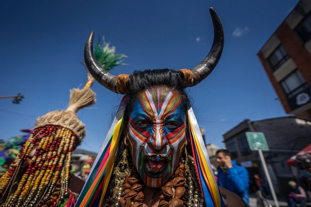 A man wearing traditional carnival disguise and face paint takes part in the Negros y Blancos Carnival on January 6, 2022 in Pasto, Colombia. This UNESCO-recognized carnival takes place every January in the Southern Andean city of Pasto. The Carnival of “Blancos y Negros” has its origins in a mix of Amazonian, Andean and Pacific cultural expressions. (Photo by Diego Cuevas/Getty Images)