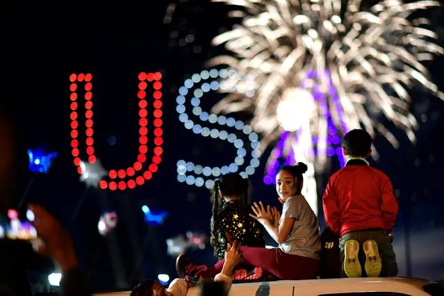 People watch fireworks after Joe Biden won the election in Wilmington, Delaware, November 7, 2020. (Photo by Mark Makela/Reuters)