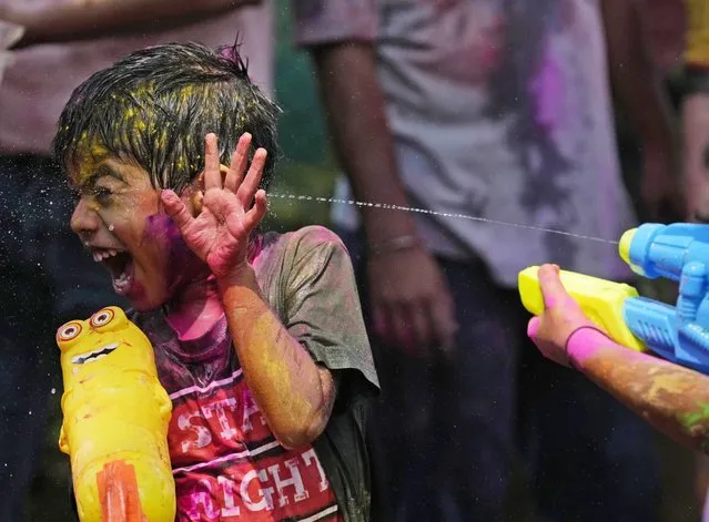 Children play during Holi, the Hindu festival of colors, in Mumbai, India, Tuesday, March 7, 2023. The festival heralds the arrival of spring. (Photo by Rajanish Kakade/AP Photo)