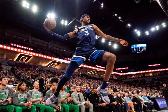 Minnesota Timberwolves forward Jaden McDaniels (3) attempts to save a ball from going out of bounds against the Boston Celtics in the first quarter at Target Center in Minneapolis, Minnesota on March 15, 2023. (Photo by Nick Wosika/USA TODAY Sports)