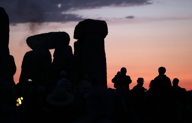 People attend the Summer Solstice at Stonehenge, Wiltshire, Britain, 21 June 2025. The summer solstice occurs when one of the Earth's poles has its maximum tilt toward the Sun. The annual festival at Stonehenge attracts hundreds of people to the 5,000-year-old stone circle to mark the longest day in the northern hemisphere. (Photo by Andy Rain/EPA/EFE)