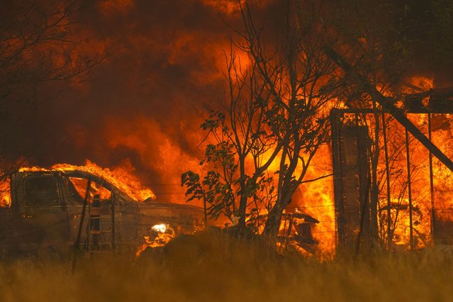 Flames engulf a home and vehicle in Chinese Camp as wildfires rage in Tuolumne County, California, U.S., September 2, 2025. (Photo by Tracy Barbutes/Reuters)