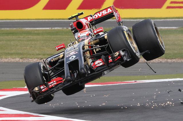 Lotus F1 team driver Pastor Maldonado goes off the track after colliding with Sauber driver Esteban Guitiererrez during the British Grand Prix at the Silverstone Race Circuit, central England, July 6, 2014. (Photo by Paul Hackett/Reuters)