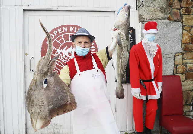 Martin McLoughlin, owner of Nicky's Plaice fishmongers, poses at his premises in the fishing village of Howth, Dublin, Ireland, Thursday, December 17, 2020. Irish coastal communities will be “annihilated” if Britain's post-Brexit fishing demands are granted, an Oireachtas committee has been told. (Photo by Brian Lawless/PA Wire via AP Photo)