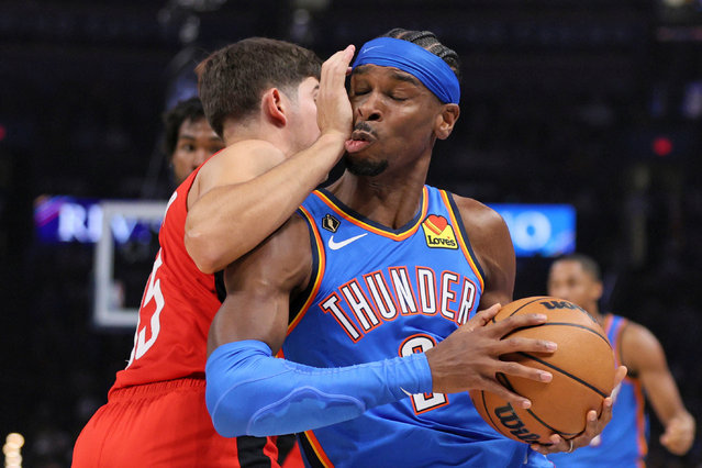Oklahoma City Thunder guard Shai Gilgeous-Alexander, right, collides with Houston Rockets guard Reed Sheppard during the first half of an NBA basketball game in Oklahoma City, on Sunday, October 19, 2025. (Photo by Nate Billings/AP Photo)