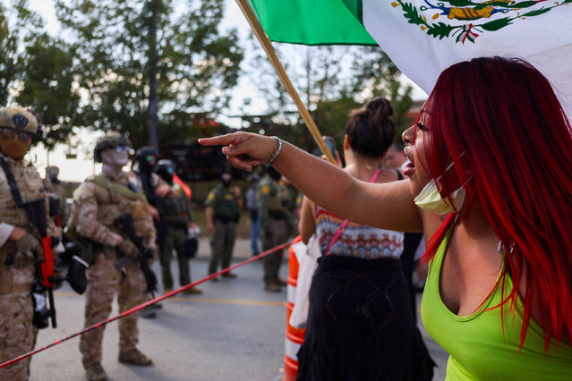 A demonstrator confronts law enforcement officers during a standoff with ICE and federal officers in the Little Village neighborhood of Chicago, on October 4, 2025. (Photo by Jim Vondruska/Reuters)