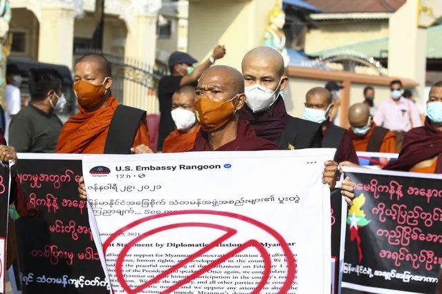 Buddhist monks hold placards as they participate in a rally protesting election results by supporters of the Myanmar military and the military-backed Union Solidarity and Development Party near Shwedagon pagoda Saturday, January 30, 2021, in Yangon, Myanmar. Myanmar’s military has denied that controversial statements by its chief were meant as a threat to stage a coup, claiming the media had misinterpreted his words. Political tension soared this past week after the military said it could not rule out a coup if its complaints of widespread voting fraud in last November’s election were ignored. (Photo by Thein Zaw/AP Photo)