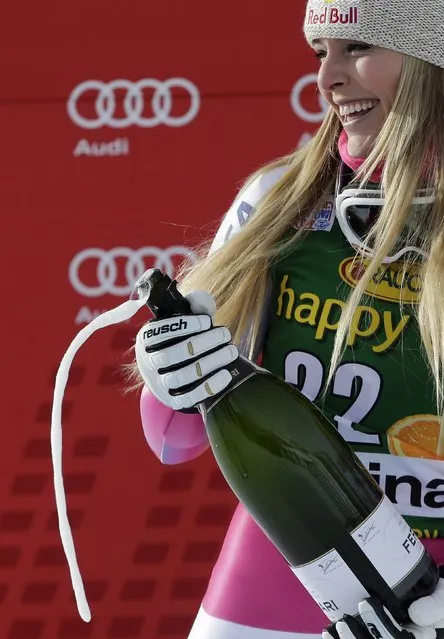 Lindsey Vonn of the U.S. sprays champagne on the podium after winning the women's World Cup Super-G skiing race in Cortina D'Ampezzo January 19, 2015. Vonn became the most successful female in Alpine skiing World Cup history when she won a Super-G on Monday, her 63rd victory in the competition. (Photo by Max Rossi/Reuters)