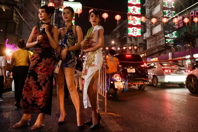 Women stand on a street ahead of the Lunar New Year celebration at the Chinatown in Bangkok, Thailand, February 10, 2021. (Photo by Chalinee Thirasupa/Reuters)
