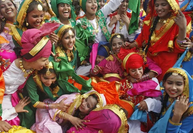 School children celebrate after winning the best cultural performance trophy during the Republic Day celebrations in the northern Indian city of Chandigarh January 26, 2015. (Photo by Ajay Verma/Reuters)