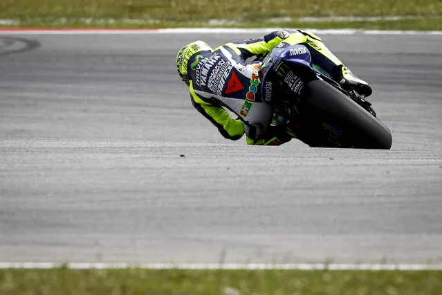 MotoGP rider Valentino Rossi of Italy leans his Yamaha in for a corner during a pre-season test at Sepang International Circuit in Sepang, Malaysia, Wednesday, February 4, 2015. (Photo by Joshua Paul/AP Photo)