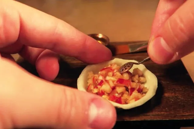 Jay fills the tiny pie crust with apples. (Photo by Jay Baron/Caters News)