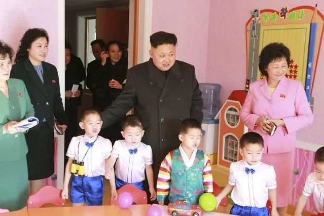 North Korean leader Kim Jong Un (C) poses for a picture with children during a visit to the Pyongyang Baby Home and Orphanage on New Year's Day in this photo released by North Korea's Korean Central News Agency (KCNA) in Pyongyang January 2, 2015. (Photo by Reuters/KCNA)