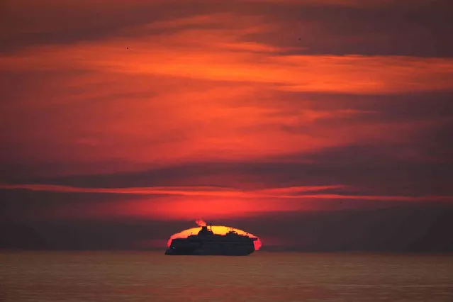 A cruise ferry floats during sunset on Summer Solstice, the longest day of the year, on the Baltic Sea near Tallinn, Estonia, Wednesday, June 21, 2023. (Photo by Sergei Grits/AP Photo)