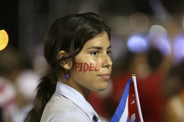 A student wearing face paint attends a tribute to former Cuban President Fidel Castro in Santiago de Cuba, Cuba, December 3, 2016. (Photo by Alexandre Meneghini/Reuters)