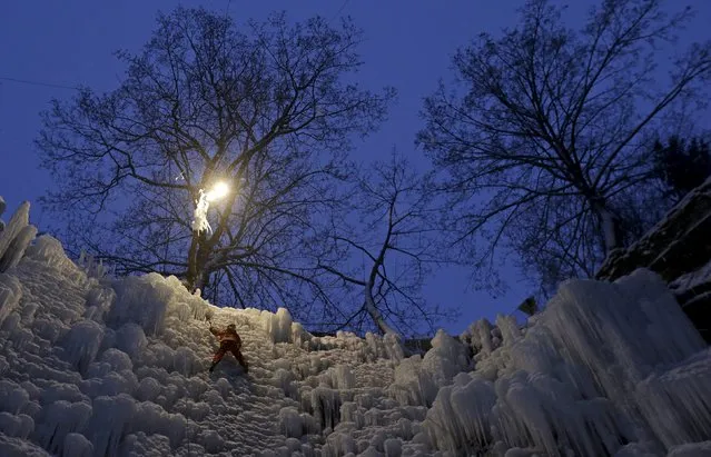 A man climbs an artificial wall of ice in the city of Liberec, Czech Republic, January 23, 2016. (Photo by David W. Cerny/Reuters)