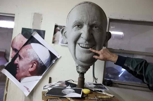 Sculptor Pedro Francisco Rodriguez works on a mold of Pope Francis' head in Ciudad Juarez January 25, 2016. Rodriguez is working to create a bronze statue of Pope Francis that will measure over 16 feet tall to mark the Pope's visit to Ciudad Juarez in February. The public can contribue to the artwork by donating bronze items at collection points set up throughout the city, according to local media. (Photo by Jose Luis Gonzalez/Reuters)