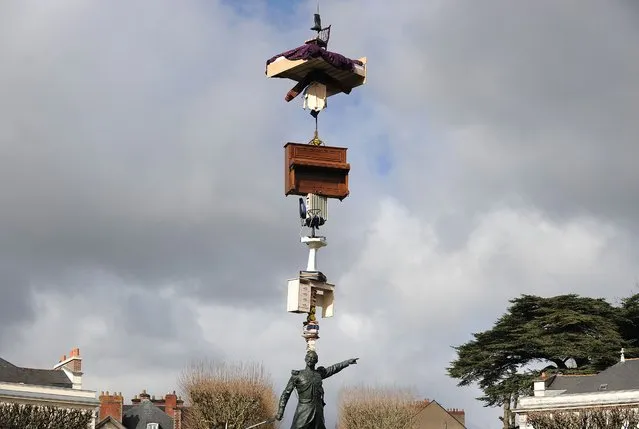 An ephemeral creation of Japanese artist Tatzu Nishi is pictured above the statue of French General Mellinet on March 13, 2015 in Nantes, western France, 4 months before the “A journey to Nantes” (Le Voyage a Nantes) art festival. The event will run from July 3 to August 30, 2015. (Photo by Jean-Sebastien Evrard/AFP Photo)
