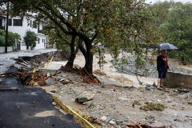 A man stands near a destroyed road after torrential rains destroyed the infrastructure and caused flooding in the area, near Volos, Greece on September 6, 2023. (Photo by Louisa Gouliamaki/Reuters)