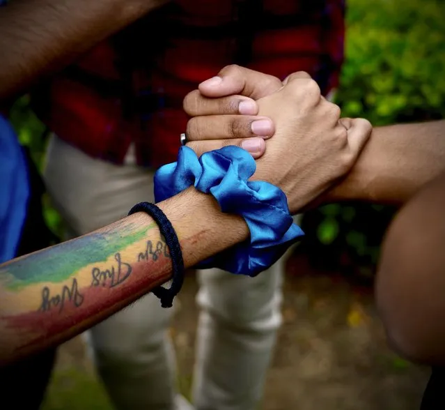 LGBTQ community supporters and members hold hands as they wait for the Supreme Court verdict on petitions that seek the legalization of same-s*x marriage, in New Delhi, India, Tuesday, October 17, 2023. Homosexuality has long carried a stigma in India’s traditional society, even though there has been a shift in attitudes toward same-s*x couples in recent years. (Photo by Manish Swarup/AP Photo)