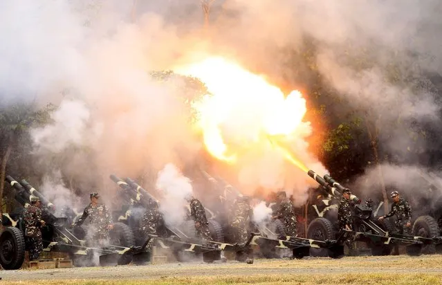 Troops fire 105mm howitzers during the celebration of the 118th Founding Anniversary of the Philippine Army at the military headquarters in Fort Bonifacio, Taguig City, Metro Manila March 23, 2015. (Photo by Romeo Ranoco/Reuters)