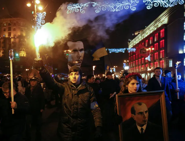 Activists of the Svoboda (Freedom) Ukrainian nationalist party hold flrares and torches as they take part in a rally to mark the 108th birth anniversary of Stepan Bandera, one of the founders of the Organization of Ukrainian Nationalists (OUN), in Kiev, Ukraine, January 1, 2017. (Photo by Valentyn Ogirenko/Reuters)