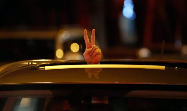 An Iranian man flashes victory sign from his cars's sunroof as people celebrate in the street of Tehran, Iran, 02 April 2015, after nuclear talks between Iran and World powers ended in Lausanne, Switzerland. (Photo by Abedin Taherkenareh/EPA)