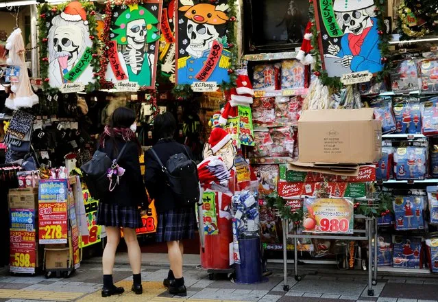 High school students enter a discount store in Tokyo's shopping district, Japan, December 1, 2016. (Photo by Toru Hanai/Reuters)