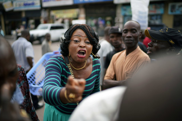 In this Friday, December 28, 2018, photo, Kinshasa residents argue about politics at a street newsstand in Kinshasa, Congo. Congolese people are heading to the polls Sunday, Dec. 30 for a presidential race plagued by years of delay and persistent rumors of lack of preparation. (Photo by Jerome Delay/AP Photo)