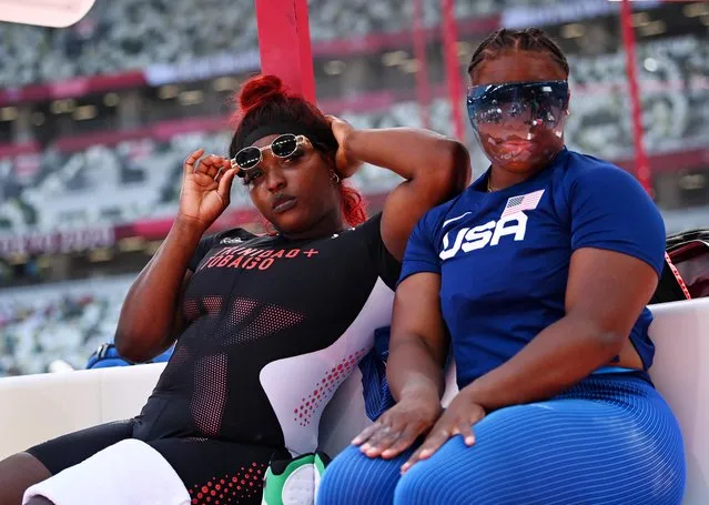 Jessica Ramsey of the United States wearing a protective face shield and Portious Warren of Trinidad & Tobago pose during the women's shot put final at Olympic Stadium in Tokyo, Japan on August 1, 2021. (Photo by Dylan Martinez/Reuters)