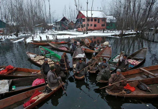 Vegetable vendors assemble at a floating market in the interior of Dal lake on a cold winter morning in Srinagar January 7, 2019. (Photo by Danish Ismail/Reuters)