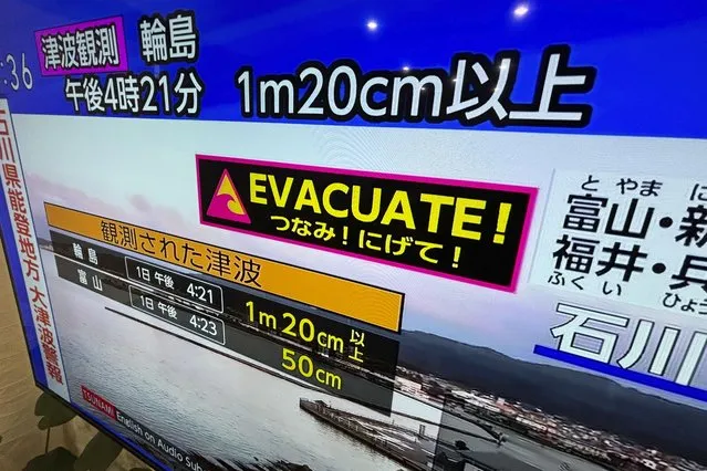 A tsunami warning is shown on TV in Yokohama, near Tokyo Monday, January 1, 2024. Japan issued tsunami alerts Monday after a series of strong quakes in the Sea of Japan. (Photo by Eugene Hoshiko/AP Photo)