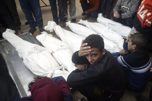 Palestinians mourn relatives killed in the Israeli bombardment of the Gaza Strip outside a morgue in Khan Younis on Thursday, January 4, 2024. (Photo by Mohammed Dahman/AP Photo)