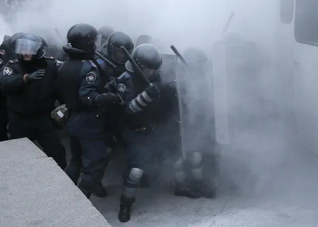 Riot police clash with protesters in central Kiev, Ukraine, Sunday, January 19, 2014. (Photo by Efrem Lukatsky/AP Photo)