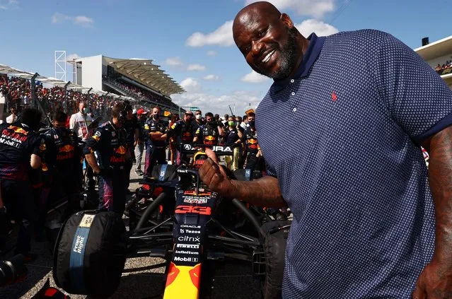 American former professional basketball player Shaquille O'Neal poses for a photo with the car of Max Verstappen of Netherlands and Red Bull Racing on the grid before the F1 Grand Prix of USA at Circuit of The Americas on October 24, 2021 in Austin, Texas. (Photo by Mark Thompson/Getty Images)
