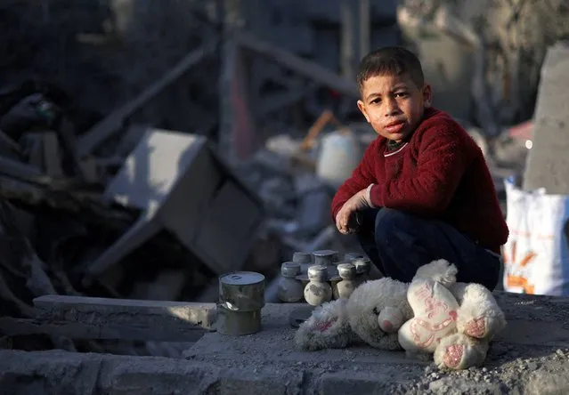 A Palestinian child looks on, at the site of an Israeli strike on a house, amid the ongoing conflict between Israel and the Palestinian Islamist group Hamas, in Rafah in the southern Gaza Strip, on February 12, 2024. (Photo by Ibraheem Abu Mustafa/Reuters)