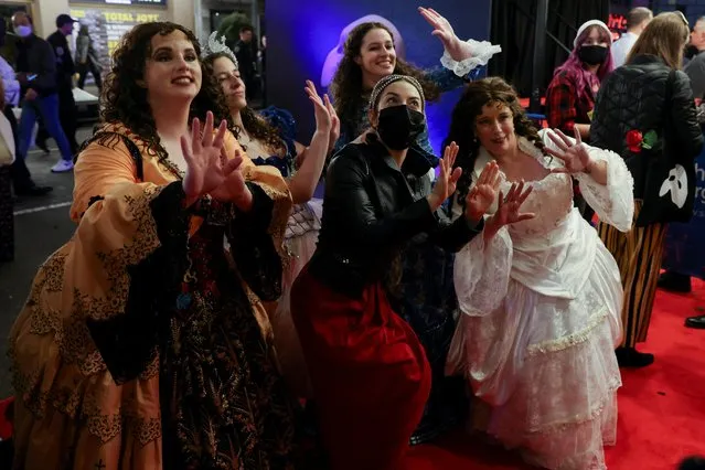 Fans dressed as Christine Daae pose with lead actor Meghan Picerno after the re-opening of “Phantom of the Opera” at the Majestic Theater in New York City, New York, U.S., October 22, 2021. (Photo by Caitlin Ochs/Reuters)
