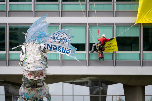 Greenpeace activists bring back to food and drinks giant Nestle a huge monster made of plastic recovered at sea and on the beaches by Greenpeace, in front of Nestle's headquarters in Vevey, Switzerland, 16 April 2019. The NGO denounced the pollution caused by single-use plastics that end up creating real continents of waste in the oceans. (Photo by Laurent Gilliéron/EPA/EFE)