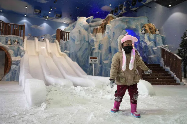 A child plays at artificial ice playground Snowalk at i-City in Shah Alam, outskirt of Kuala Lumpur, Malaysia, Saturday, October 9, 2021. (Photo by Vincent Thian/AP Photo)
