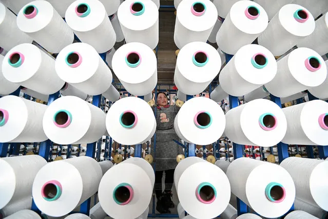 An employee checks cloth at a textile factory in Handan, in northern China's Hebei province on February 29, 2024. (Photo by AFP Photo/China Stringer Network)