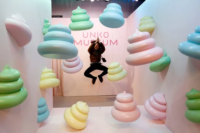 A visitor jumps to pose for a photo behind a display at the the Unko (“poop” in Japanese) museum in Yokohama, Japan, April 17, 2019. (Photo by Kim Kyung-Hoon/Reuters)