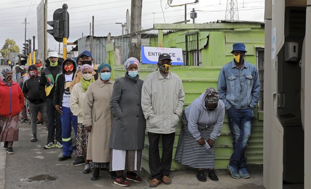 People queue outside a polling station in Khayelitsha in Cape Town, South Africa, Monday, November 1, 2021. As South Africa holds crucial local elections, the country has been hit by a series of crippling power blackouts that many critics say highlight poor governance. (Photo by Nardus Engelbrecht/AP Photo)