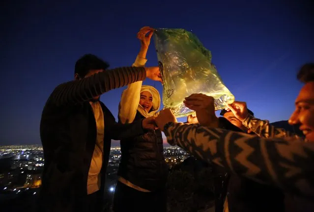 Young people release wishing lanterns during a traditional fire feast called “Charshanbeh Suri” in Tehran, Iran, 12 March 2024. The festival is held annually on the last Wednesday eve before the Persian New Year (Nowruz), which starts on 20 March this year, also marking the beginning of spring. Nowruz, which has been celebrated for at least three thousand years, is the most revered celebration in the Greater Persian world, which includes the countries of Iran, Afghanistan, Azerbaijan, Turkey, and portions of western China and northern Iraq. (Photo by Abedin Taherkenareh/EPA/EFE)
