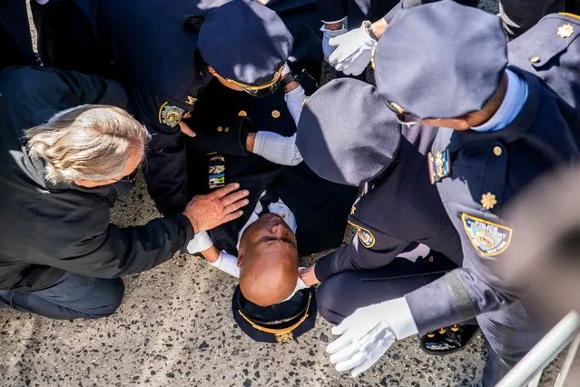 A police officer passes out during a funeral service of New York Police Department (NYPD) Officer Jonathan Diller, a three-year veteran of the NYPD on the specialized Community Response Team, who was shot and killed March 25 during traffic stop, at the St. Rose of Lima Roman Catholic Church in Massapequa Park, New York on March 30, 2024. (Photo by Eduardo Munoz/Reuters)