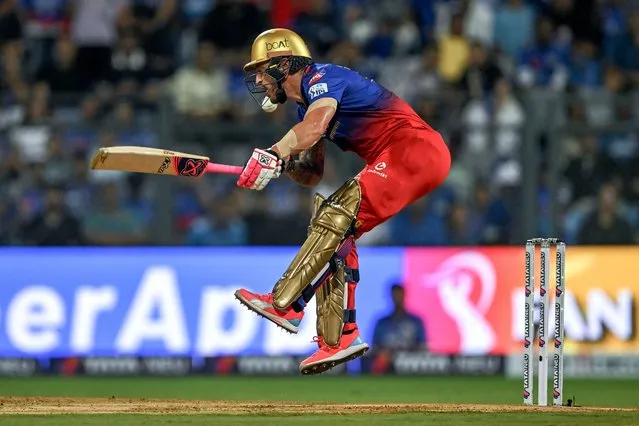 Royal Challengers Bengaluru's captain Faf du Plessis reacts after being hit by the ball during the Indian Premier League (IPL) Twenty20 cricket match between Mumbai Indians and Royal Challengers Bengaluru at the Wankhede Stadium in Mumbai on April 11, 2024. (Photo by Indranil Mukherjee/AFP Photo)