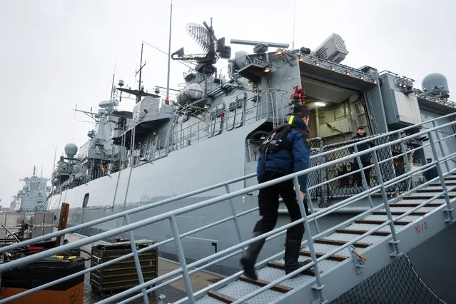 A crew member steps aboard the frigate F 218 Mecklenburg-Vorpommern of the German Navy before the ship left its home port in Wilhelmshaven, northwestern Germany, for the NATO Very High Readiness Joint Task Force (VJTF) on January 4, 2023. The Brandenburg class vessel will join the NATO VJTF on the northern flank in the North Atlantic and on the Baltic Sea as flagship of the new German commander of the mission. (Photo by Focke Strangmann/AFP Photo)