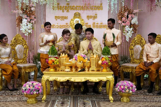 Leang Phannara and Kim Bethyliza attend their traditional Khmer wedding ceremony after it was delayed for months due to the coronavirus disease (COVID-19) restrictions in Phnom Penh, Cambodia on January 29, 2021. (Photo by Cindy Liu/Reuters)