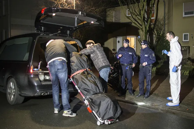 Undertakers lift a stretcher with a bodybag into a hearse in Herne, Germany, Tuesday, March 7, 2017. German police said Tuesday they have launched a manhunt for a 19-year-old man who allegedly killed a 9-year-old boy in the western town of Herne and boasted about the murder on a video posted online. (Photo by Marcel Kusch/DPA via AP Photo)