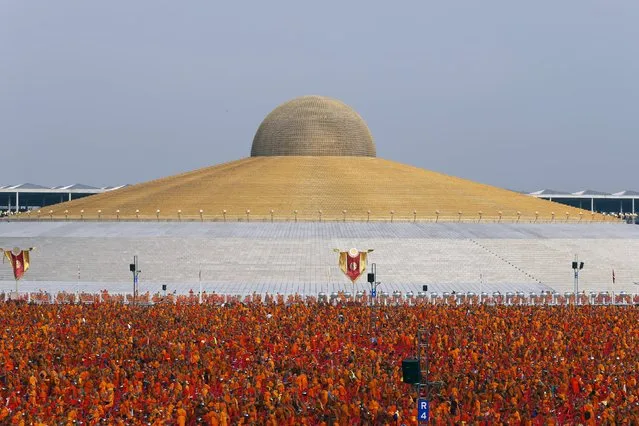 Buddhist monks and novices gather to receive alms at Wat Phra Dhammakaya temple, in what organizers said was a meeting of over 100,000 monks in Pathum Thani, outside Bangkok, April 22, 2016. (Photo by Jorge Silva/Reuters)