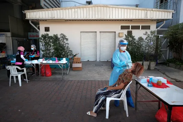 A traveler undergoes an antigen test for COVID-19 coronavirus after arriving at Mo Chit – Bangkok Bus Terminal, in Bangkok, Thailand, 03 January 2022. The Thai government has ordered state agencies' official and business firms' employees to work from home after the New Year holiday in a bid to contain the surge of COVID-19 coronavirus infections linked with the Omicron variant. (Photo by Diego Azubel/EPA/EFE)
